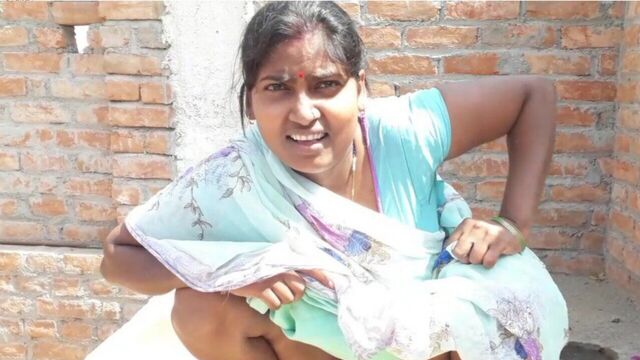 Beautiful Indian bhabhi pissing on her house roof and fingering her cremei tight pussy